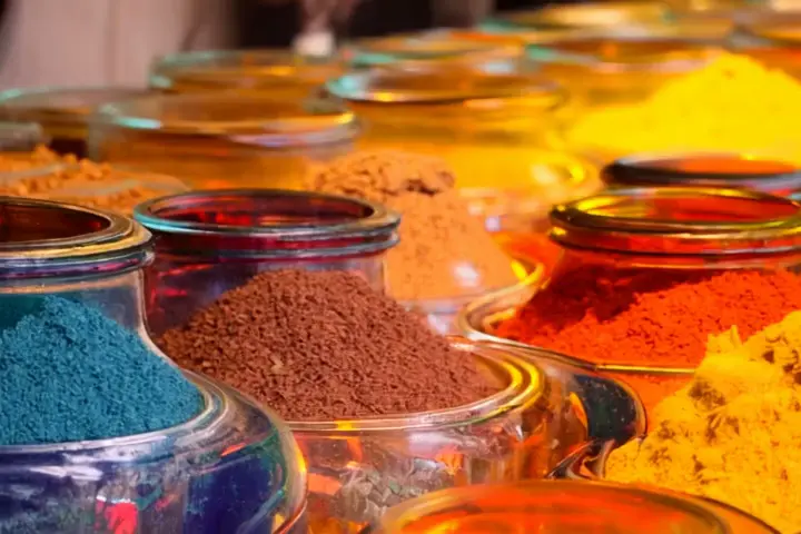 Market stall of spices → Painter mixing oil colors