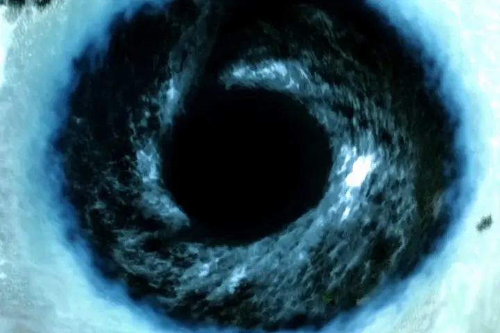 Ocean vortex swirling → Close up blue eye